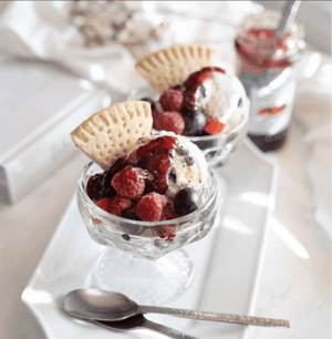 Classic ice cream sundae topped with St. Dalfour's Four Fruit spread and fresh berries